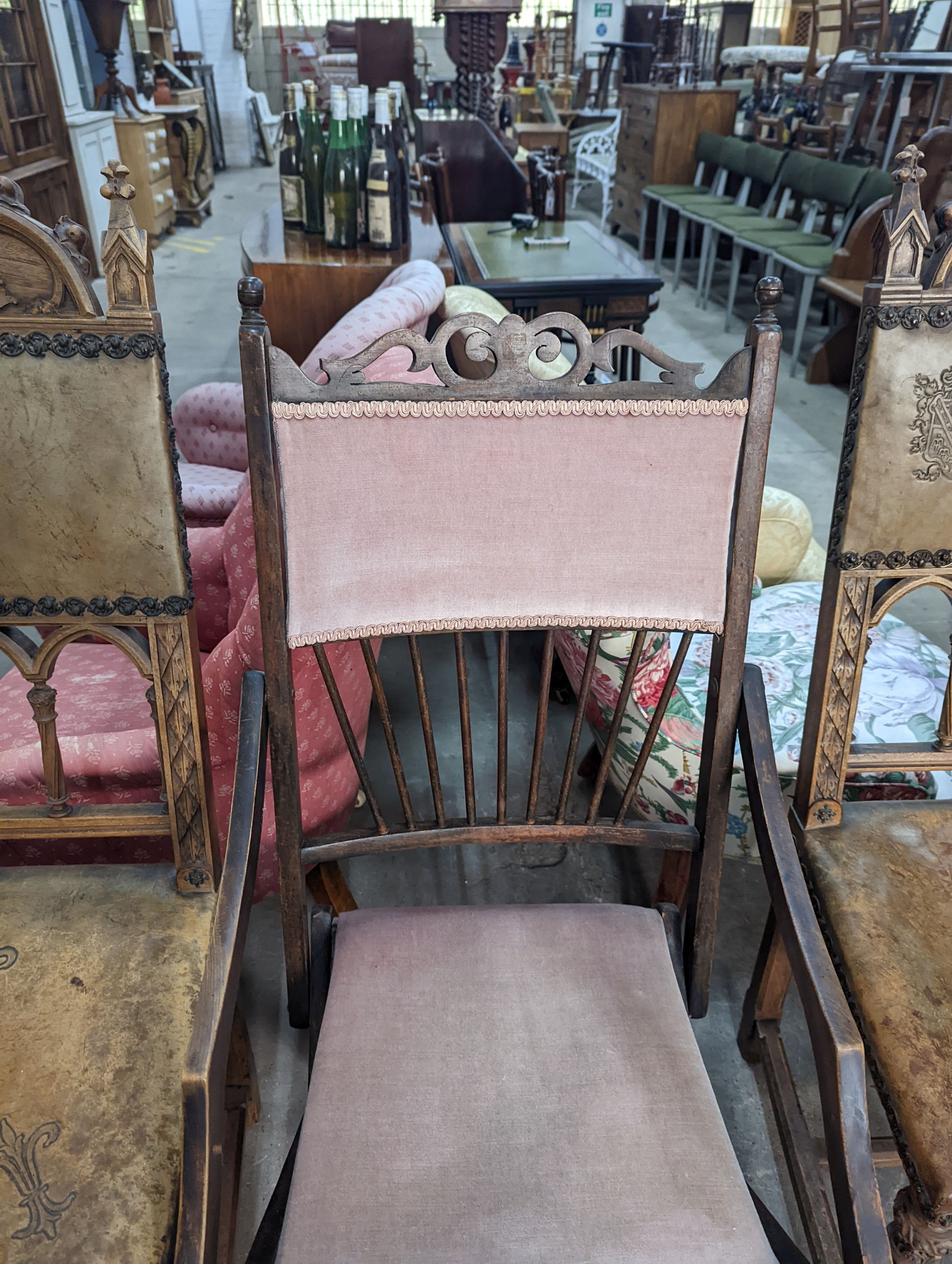 A pair of Gothic style carved walnut and leather side chairs together with an Edwardian beech folding chair